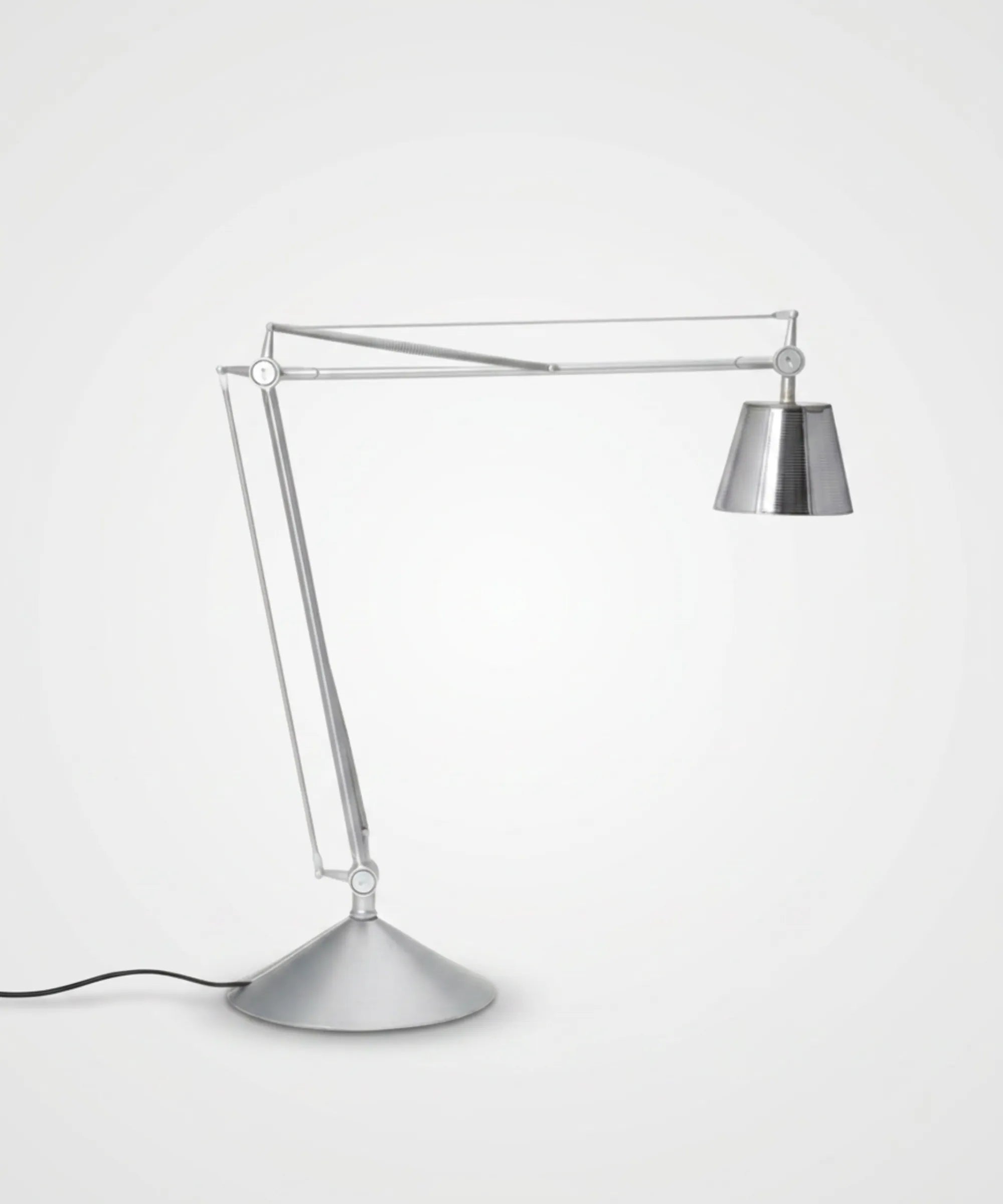 Flos Archimoon K lampada da tavolo in finitura argento con bracci a pantografo testa orientabile e base a disco design Philippe Starck vista prospettica su sfondo neutro